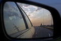 Sunset in a traffic jam on the road through the right side mirror in the car Royalty Free Stock Photo